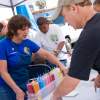 Janis Ambrosiani passing out colors at the OB Community Mural booth